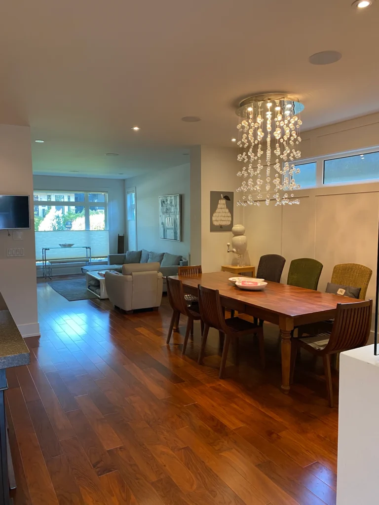 Dining area with a glass chandelier and wooden table