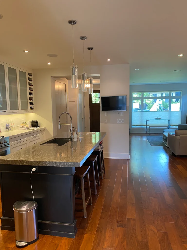Kitchen with a central island and adjacent living room